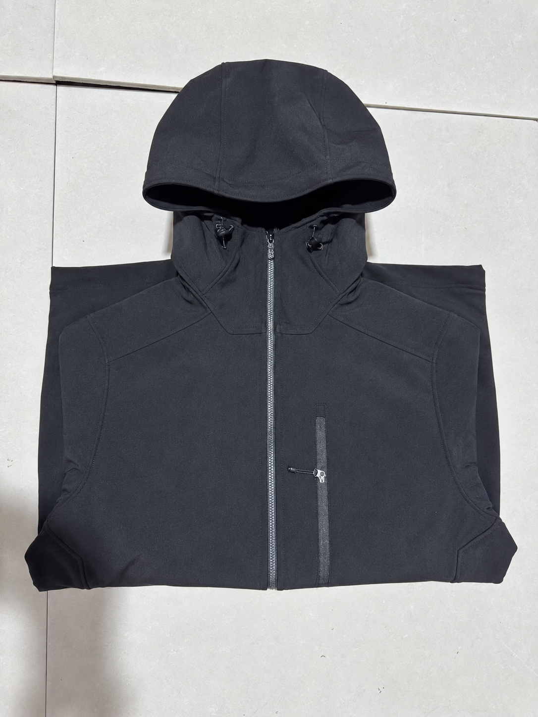 Black hooded work jacket front view.
